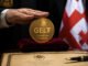GEL₮ Georgian lari stablecoin displayed with official ceremony setting and Georgian flag symbolizing Tether-backed national payment rail expansion in Georgia