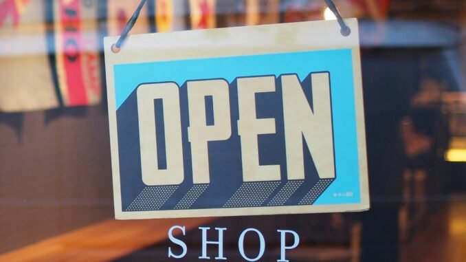 Open shop sign in a store as SAP and Google Cloud are deploying agentic commerce architecture to automate multi-agent marketing and retail operations at enterprise scale.